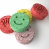 High-purity ecstasy pills in various shapes, colors, and logos (like Tesla or Punisher) displayed on a neutral background for use with a digital pill identifier.